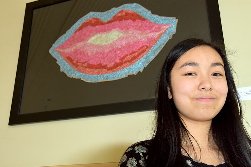 Brielle Chan with her "trash art" titled Kiss.