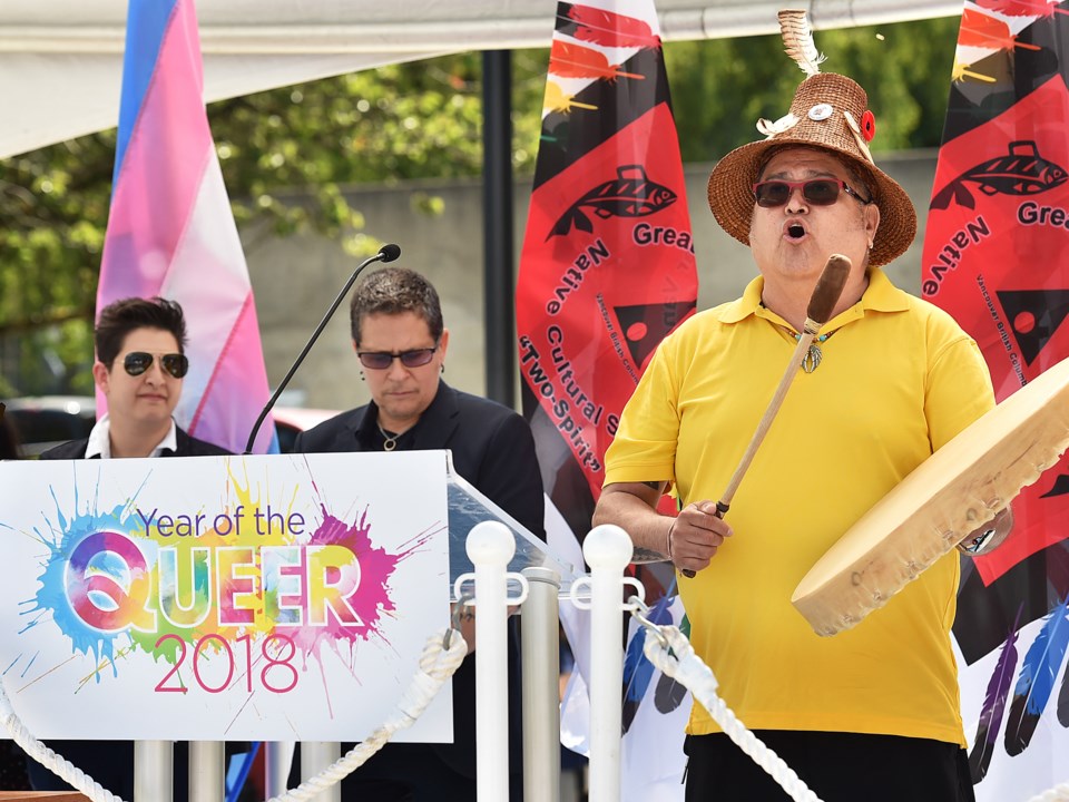 Fay Nass and SD Holman watch as Stewart Gonzales blesses "Year of the Queer" celebrations.