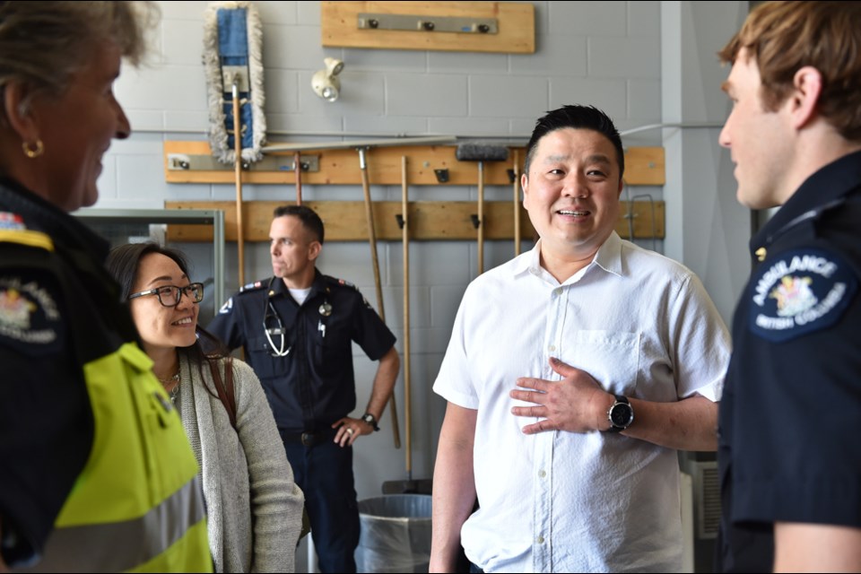 Vincent Bo and his wife Hannah speak with the paramedics who helped save Boh's life after he had a heart attack in February at the downtown location of Steve Nash Fitness World.
