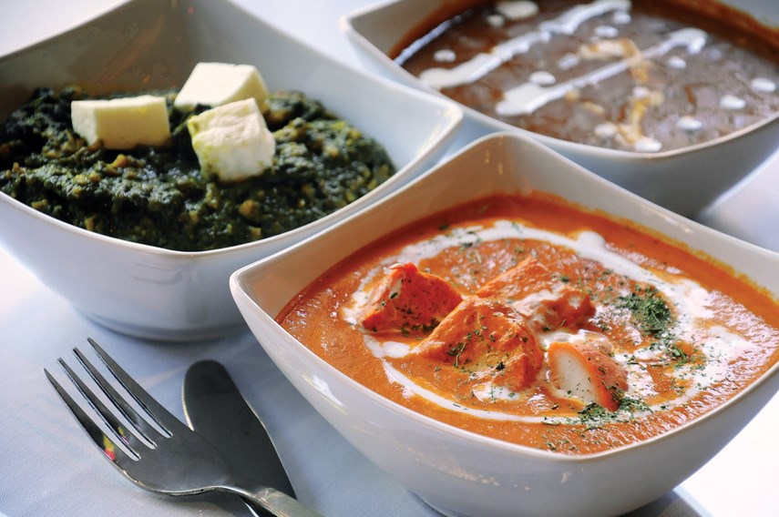 Delhi Belly dishes include Butter Chicken, Palak Paneer, Daal, Garlic Naan and Basmati Rice.