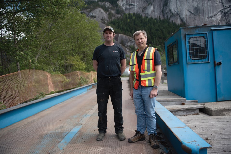 Forestry Association director Eric Andersen, to the right, and Phil Mazzotti of Squamish Mills at the site of the truck scale that was recently moved due to erosion.