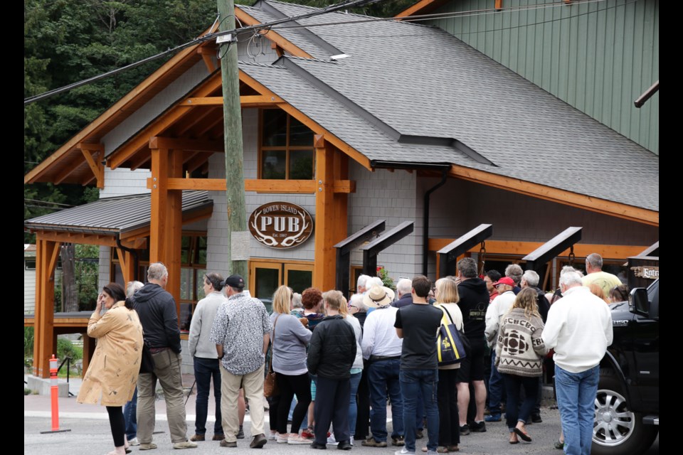 People start accumulating at the end of Dorman Road at around 3 p.m. Friday afternoon as they wait for the new pub's ribbon cutting.