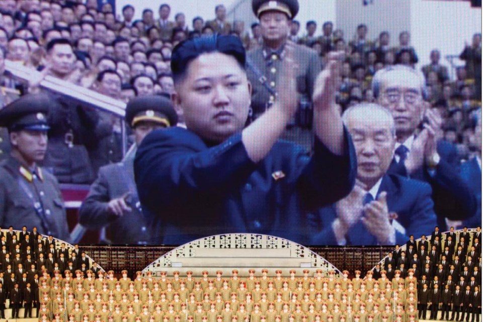 North Korean performers sit beneath a screen showing images of leader Kim Jong-Un at a theatre during celebrations to mark the 100th anniversary of the birth of the country's founding leader, Kim Il-Sung, in Pyongyang earlier this year.