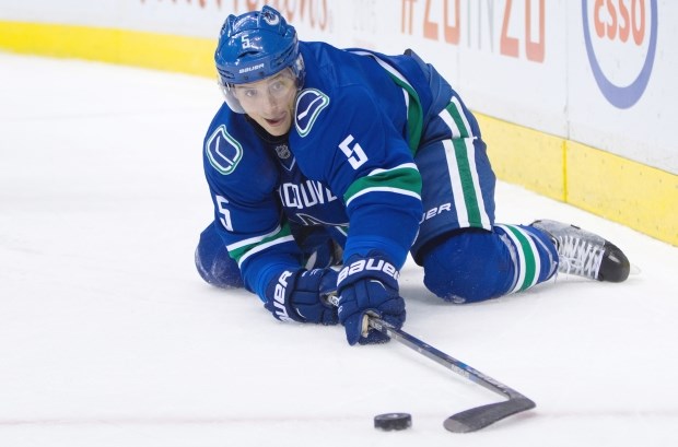 Luca Sbisa playing the puck from his knees for the Vancouver Canucks.