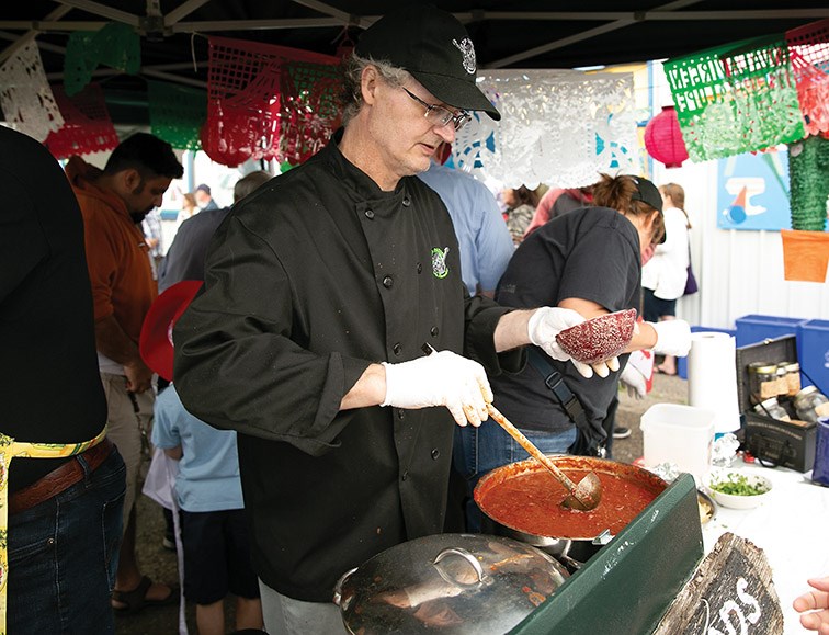 Brian Halverson of Team CFIS scoops a ladle full of chili on Saturday during the 42nd Annual Chili Fest and Spring Arts Bazaar. Team CFIS was looking to once again claim the title having won the chili competition the past two years.