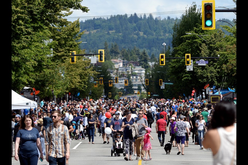 The crowds stream down Hastings Street.