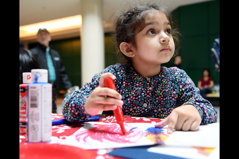 Arya Anaum, 3, colours at the ArtsToGo workshop at the Royal City Centre on Sunday.