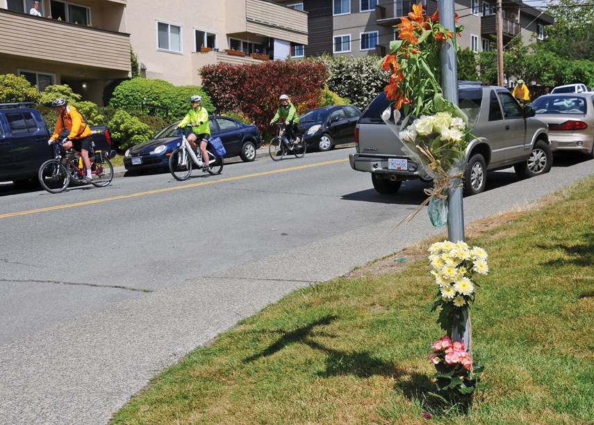 Floral tributes mark the site of a fatal collision Friday at St. Andrews Avenue and East Second Street involving a cyclist and a dump truck. The 55-year-old cyclist, identified as Brian Hughes of North Vancouver, died at the scene. photo Cindy Goodman, North Shore News