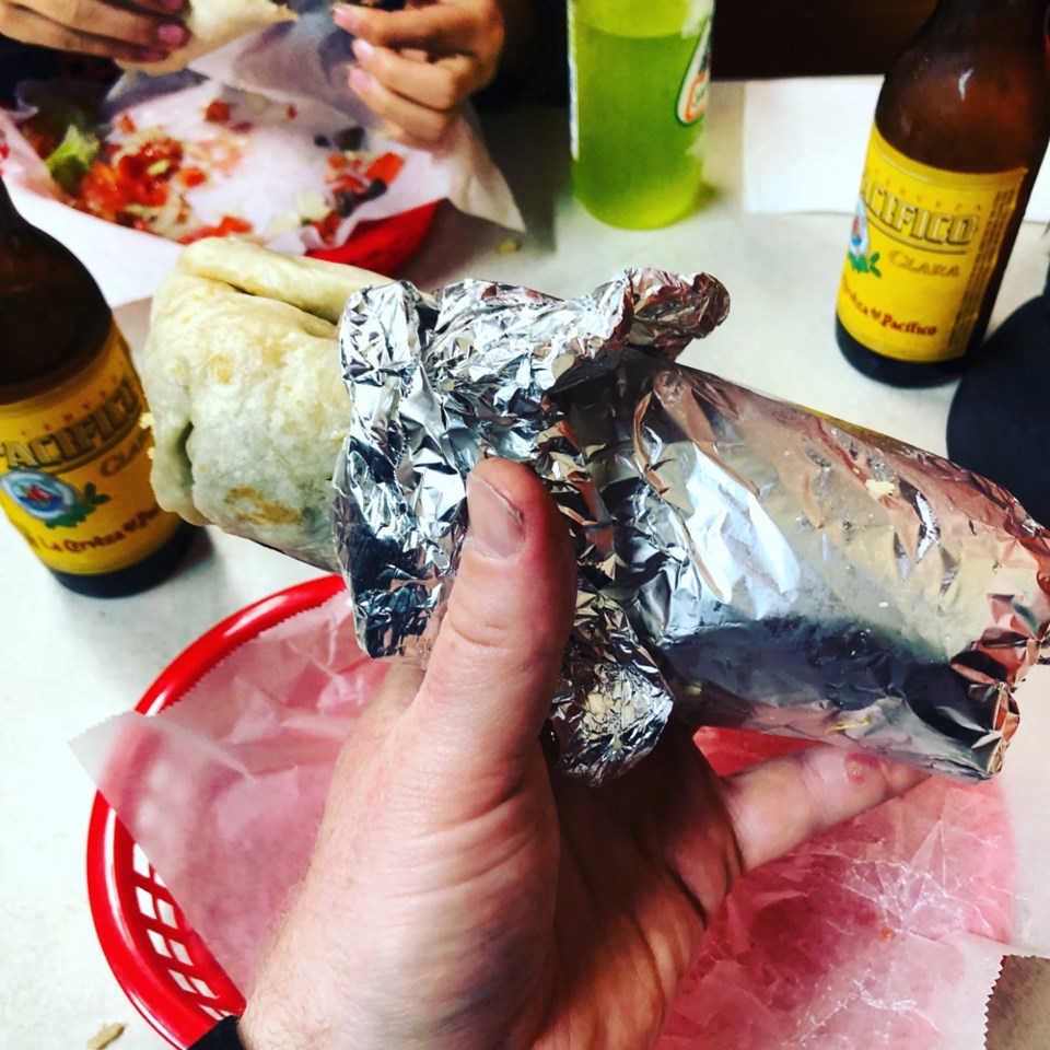 Locals and visitors come from far and wide to get their paws on El Farolito’s massive burritos. Phot