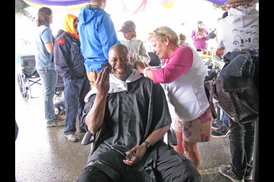 Chuck Nisbett checks out his missing hair as friend Joyce Clarke shaves everything but the eyebrows during the annual Prince George Relay for Life organized by the local branch of the Canadian Cancer Society. The event held at its new location at Exhibition Park went from Saturday at 10 a.m. until Sunday at 10 a.m. This is the only 24-hour relay in Canada.
