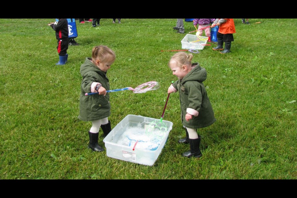 Twins Teagan and Aubrie, 21 months old, played with bubbles during the Early Years Wellness Fair held at Lheidli T'enneh Memorial Park Saturday, which the girls attended with their parents Brittany and Mike Jones.
