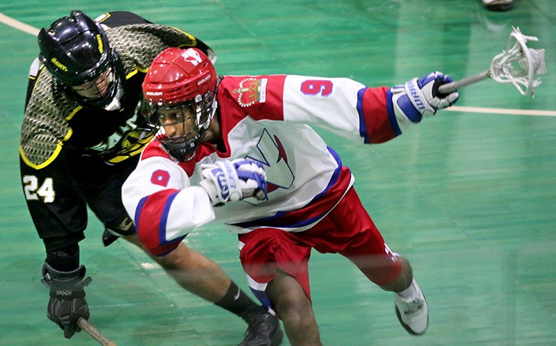 MARIO BARTEL/THE TRI-CITY NEWS
New Westminster Salmonbellies runner Naoll Degife tries to get away from the check of PoCo Saints defender Clark Waltersin the first period of their BC Junior A Lacrosse League game, Tuesday at Queen's Park in New Westminster. PoCo won the game, 7-6.