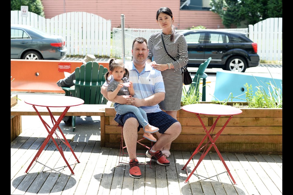 utt out: Adrian Beer, with his daughter Sophia and wife Lynn, wants the city to do more to stop smoking at the Belmont Street parklet.