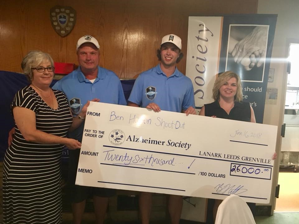 Ben Hutton and his parents present a cheque for $26,000 to the Alzheimer's Society