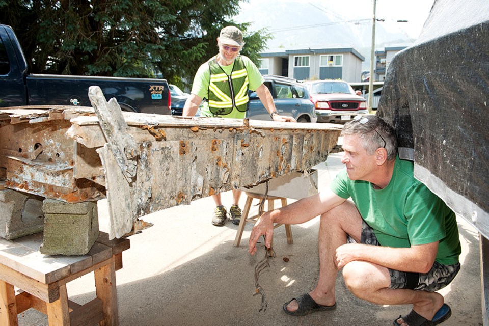 John Buchanan (front) and Carl Halvorson examine the wing they uncovered.