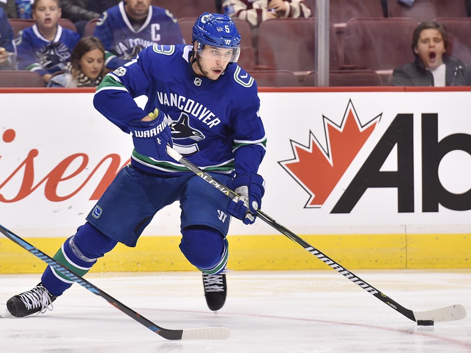 Derrick Pouliot skates with the puck for the Vancouver Canucks.