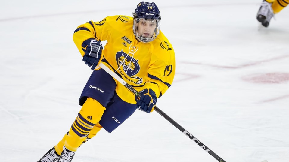Tanner MacMaster skates up ice for the Quinnipiac University Bobcats.