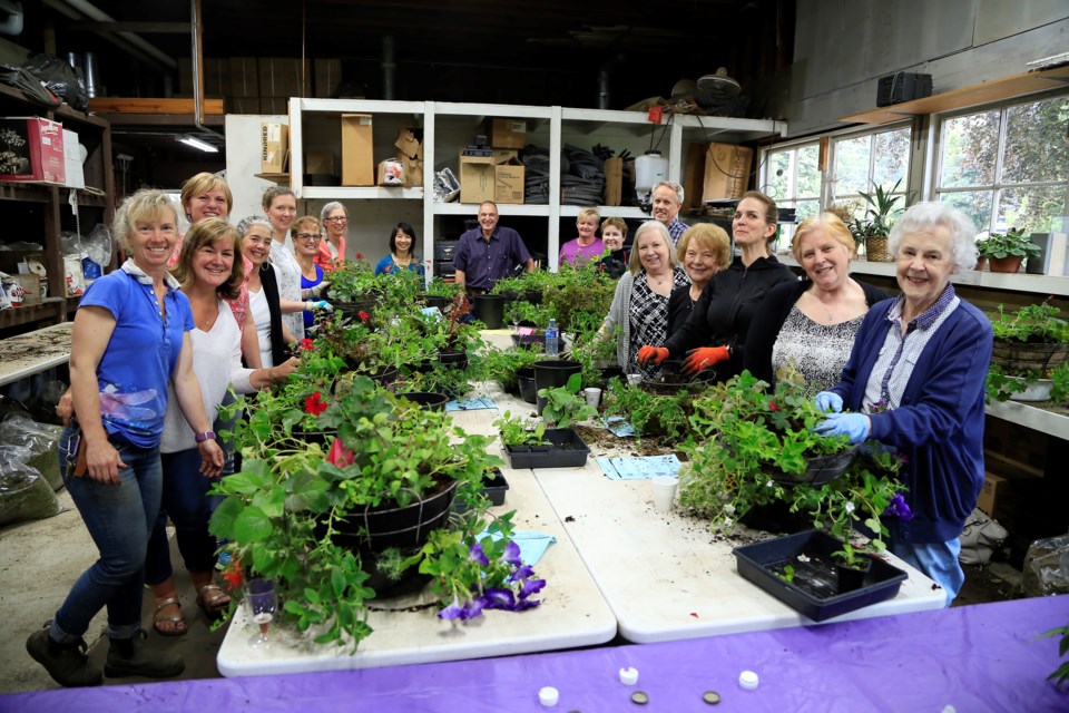 Hundreds of folks took part in the City of New Westminster's annual hanging basket classes this spring, learning the secrets of the city's beautiful baskets from city horticulture manager Claude LeDoux, centre.