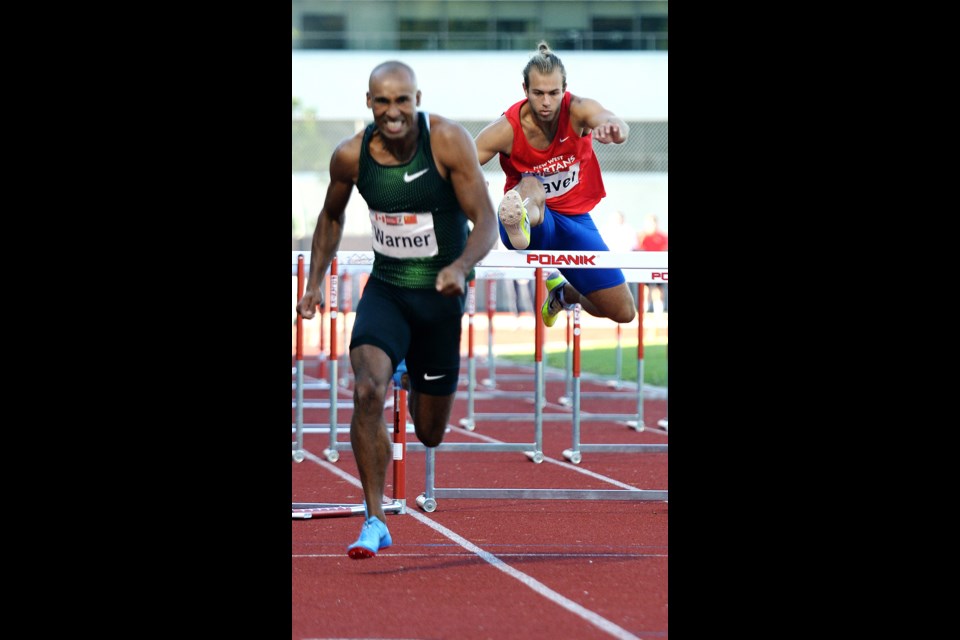 New Westminster Spartans track member and UBC runner Bogdan Pavel, at right, chases No. 1 ranked decathlete Damian Warner in the 110-metre men's hurdles on Tuesday at the Harry Jerome International Track Classic at Swangard Stadium.