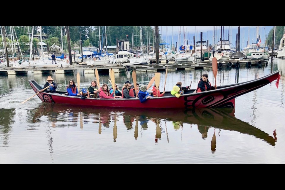The Dancing Raven out for a turn in Snug Cove earlier this month. Squamish elder Bob Baker is in the stern of the boat, with students, from left to right, Cree, Nalia, Nicola, Ryuki, Alex, Lucas, Mizuki, and Luman. Educational assistants were also along for the canoe ride.
