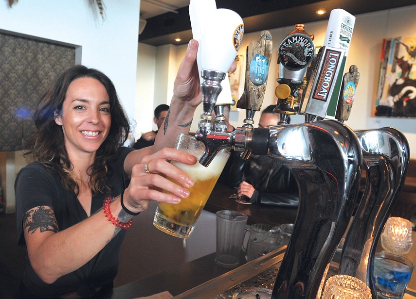 Manager Samantha Carins pours a pint at Finch & Barley.