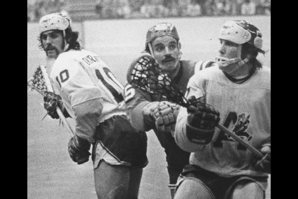 As a member of the Coquitlam Adanacs, Dave Durante, at left, had to battle the likes of New West's Steve d'Easum, centre, and alongside lacrosse great Bill Bradley, at right.