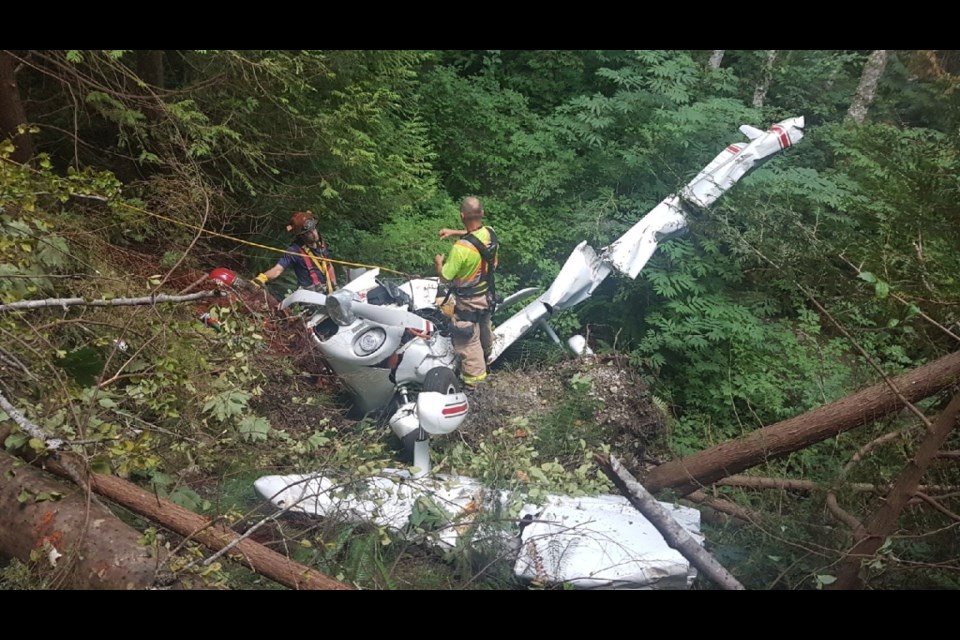 Crews work to stabilize the wreckage of a small plane that crashed near the Sechelt Airport July 5, killing the pilot.