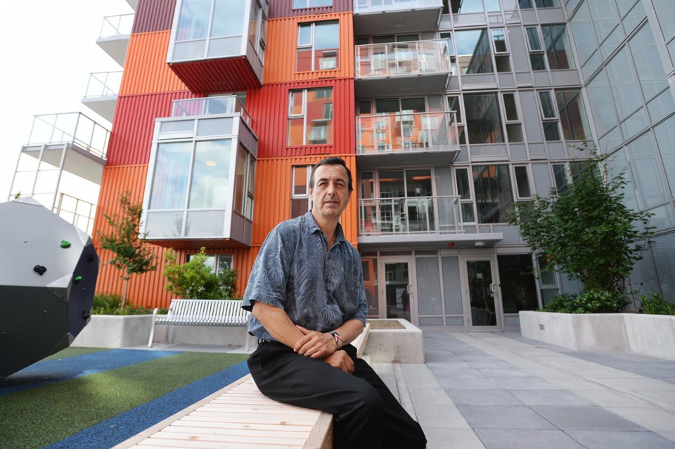 Vincent Belcourt, Josie Belcourt's husband, on the second-floor patio of Belcourt Residence. The bui