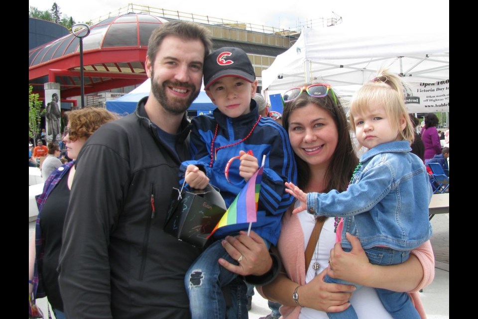 Ben Laverdure, holds son, Evan, 4, while mom Leanne holds daughter, Mya, 1, during the BMO Kidz Art Dayz held Saturday in Canada Games Plaza.