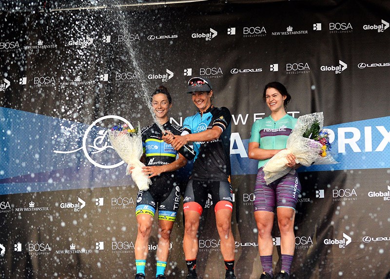 Sara Bergen of Coquitlam, centre, pops the cork on the podium after winning the New Westminster Grand Prix on Tuesday.