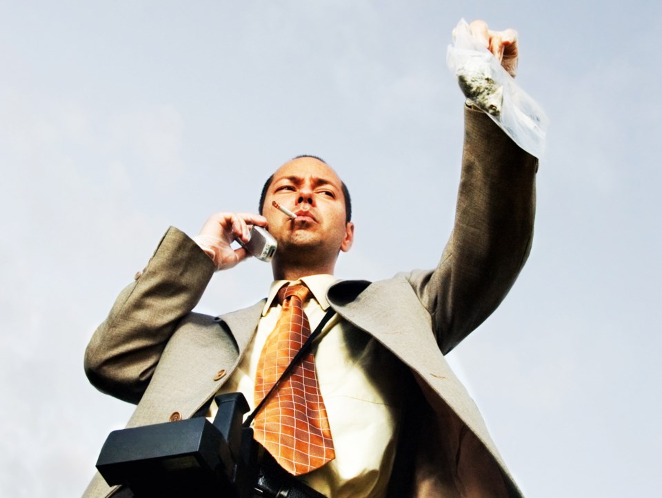 Man in suit smoking marijuana