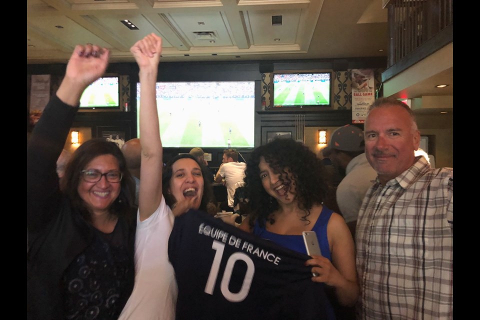 French fans celebrate in the Games Room of the Strathcona Hotel.