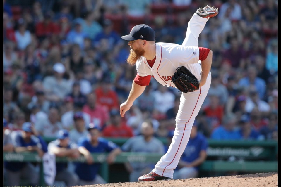 Boston Red Sox's Craig Kimbrel follows through on a pitch against the Toronto Blue Jays in the ninth inning of a baseball game, Sunday in Boston.