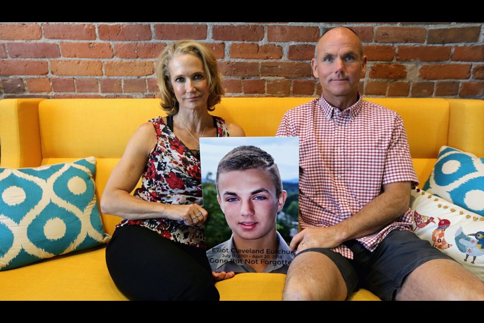 Rachel Staples and Brock Eurchuk with a photo of their son Elliot. July 2018