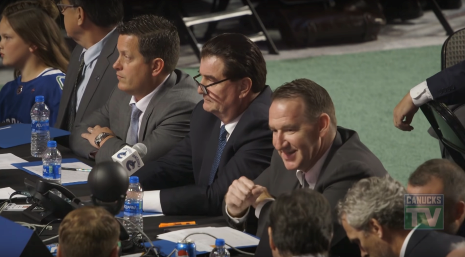 Judd Brackett, Jim Benning, and John Weisbrod at the 2018 NHL Draft.