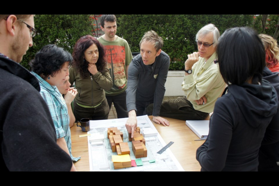 Charles Durrett ( on the right side wearing glasses) helped design the city's first cohousing project — Vancouver Cohousing in East Vancouver.