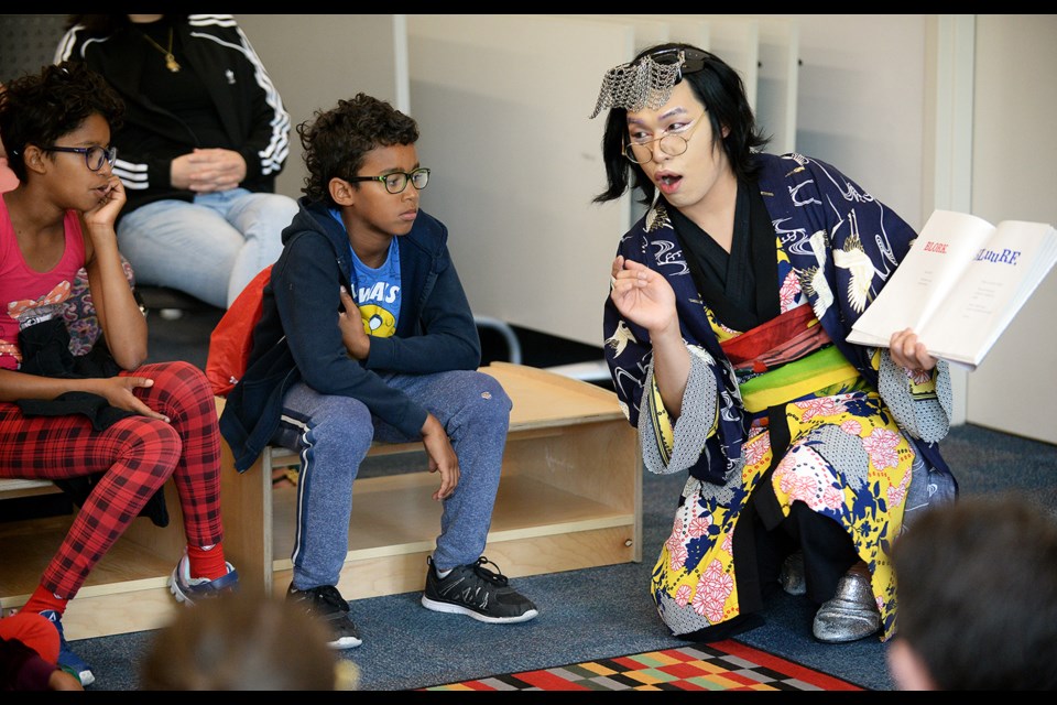 Gay Sha reads during the drag queen storytime.