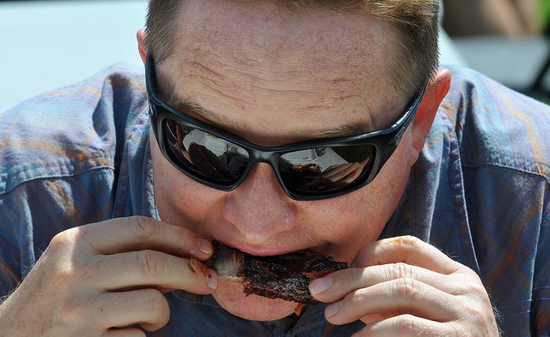 MARIO BARTEL/THE TRI-CITY NEWS
Eric Mason digs into his rib lunch at the opening day of Port Moody's fourth annual RibFest on Friday.