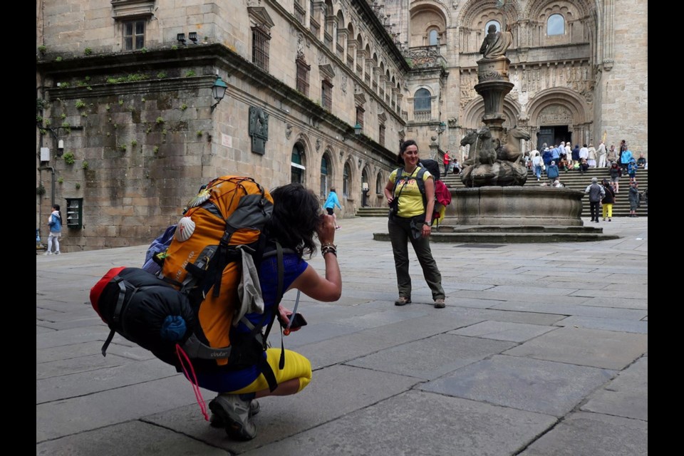 Hikers, called pilgrims, celebrate the end of their journey after walking hundreds of miles on El Camino de Santiago.