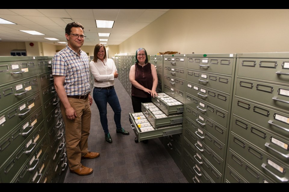 John Durno, left, Lisa Goddard and Tina Bebbington in the microfilm area at the University of Victoria's McPherson Library.