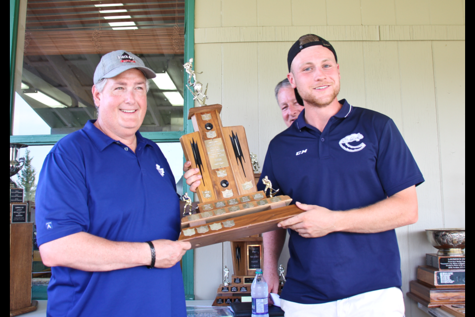 Flyers General Manager Lee Hartman presents the Rookie of the Year Award to Lien Miller-Jeannotte.