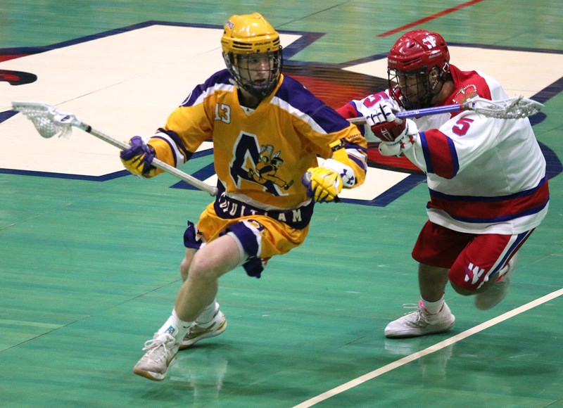 MARIO BARTEL/THE TRI-CITY NEWS
Coquitlam Adanacs forward Dylan Foulds tries to escape from New Westminster Salmonbellies defender Kobe Noda in the first period of the fourth game of their BC Junior A Lacrosse League final, Tuesday at Queen's Park Arena in New West. Coquitlam won the game, 12-5, to tie the series at 2-2.