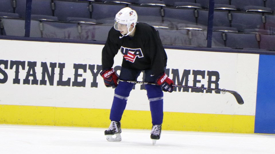 Quinn Hughes rests during a Team USA practice.