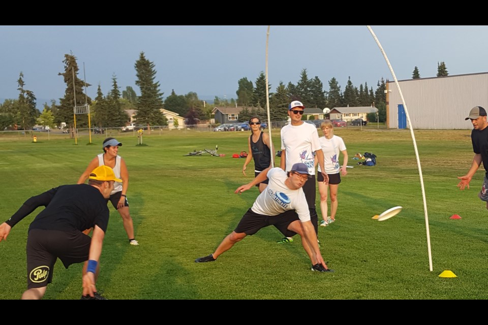 In a game of goaltimate, John Bowes, far left, passes through the hoop to Mike Connor, far right. Also in the photo, from left, are: Breanne Reinheimer, Russell Reimer, Sarah Hollett, Nathan Reinheimer and Lindsay Van Der Meer. The Swamp Donkey team members were practicing at D.P. Todd field for the Canadian ultimate mixed masters championship in Surrey, Aug. 25-36.