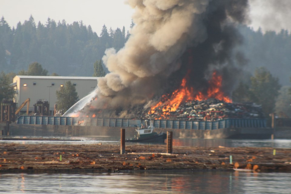 The barge enveloped in flames on the Fraser River.