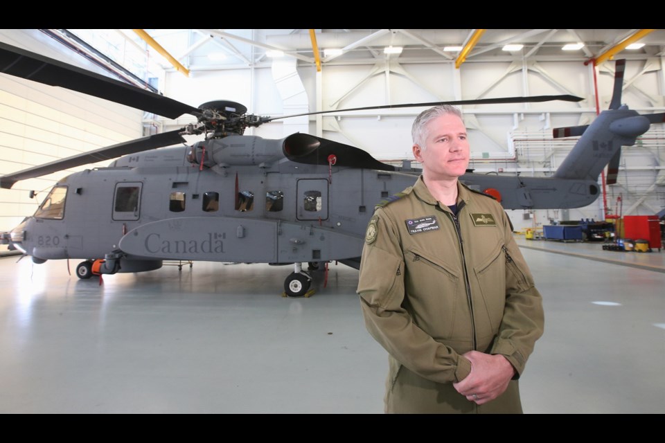 Lt. Col. Travis Chapman with a CH-148 Cyclone helicopter at the 443 Squadron base in North Saanich at Patricia Bay.