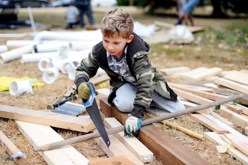 Eight-year old Aiden Allenby tackles some sawing.