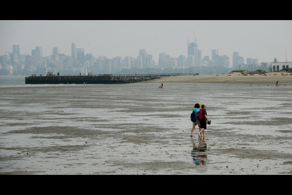An unusually low number of pedestrians dotted the shoreline of Spanish Banks at low tide Monday afternoon. An air quality advisory was issued on Monday, due to wildfire smoke from fires across B.C. and the Pacific Northwest.