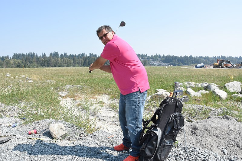 Kwikwetlem First Nation Chief Ron Giesbrecht takes a swing at the spot where the band plans to build a health and wellness centre which it is raising money for by holding a golf tournament on Aug. 23.