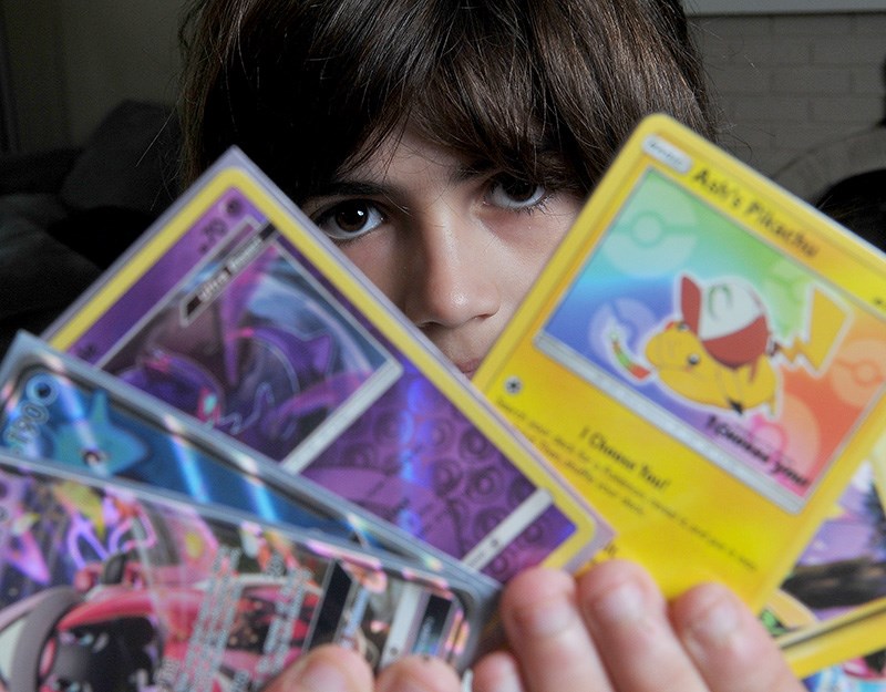 Colin Blais shows off some his favourite Pokémon cards. The Grade Five student at Cedar Drive elementary school in Port Coquitlam is travelling to Nashville, Tenn., later this month to compete at the Pokémon World Championships.
